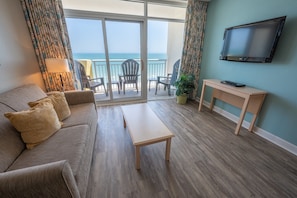 - Unwind in this inviting living room with breathtaking ocean views from your balcony - Cozy space with a large HDTV, perfect for relaxing after a long day by the beach - Enjoy a peaceful evening with the fresh sea breeze and endless views