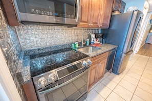 - Cook with ease in this fully equipped kitchen with modern appliances and stylish finishes - Sleek design and plenty of counter space make meal prep simple and enjoyable - Whether it's a quick snack or a full meal, everything you need is right here