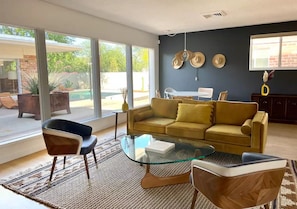 Living room overlooks interior courtyard and pool