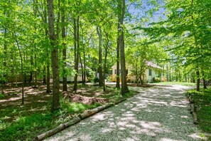 View from street entrance and parking area on gravel driveway.