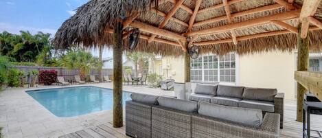 The 'Backyard Oasis' with pool, tiki hut, weather-proof furniture, and table