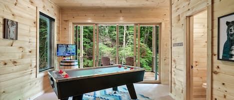 Who's up?  Air hockey and arcade games await in the basement with a gorgeous view of the land outside of the huge sliding glass doors.
