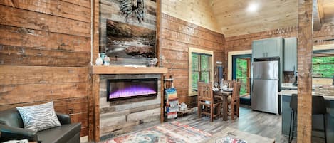 This cozy living room invites you in with a queen size sleeper sofa, and electric fireplace for year-round ambiance.