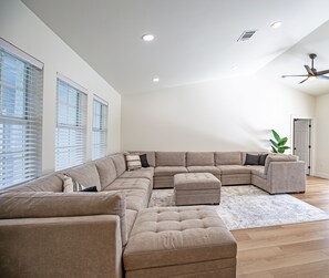 Living room with 2 large couches and lots of sitting area