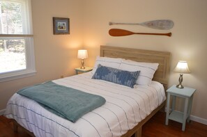 First floor bedroom with queen bed and 50 TV