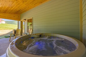 Cozy round hot tub on the back porch