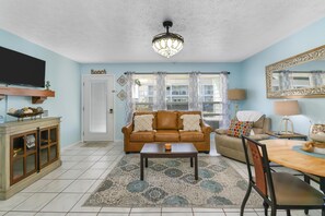 Spacious living room with a  sleeper sofa. 