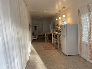 View of apartment upon entry with bedroom on left- curtain closed. 