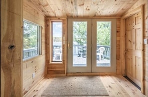 Inside view of porch, w/ lookout over water. 