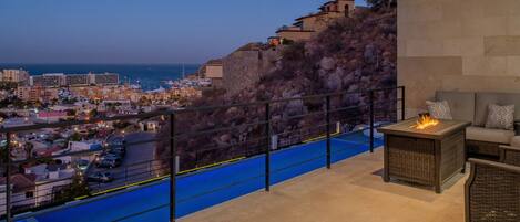 Terrace with city and ocean view at night