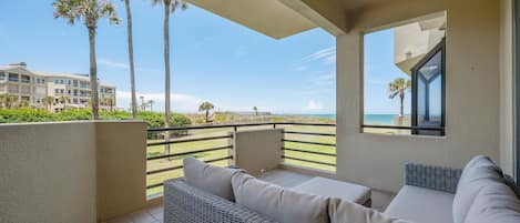 Spinnakers Reach 833 Promises Ocean Views - A cushioned sectional offers a prime spot to listen to the sound of the surf.