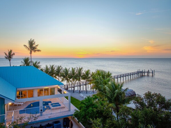 Aerial shot of the 2nd story pool area and the dock (sunset)