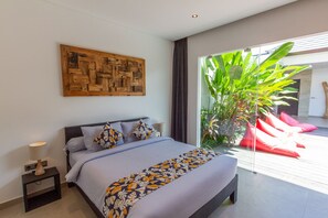 Spacious bedroom with a view of the lounging area 