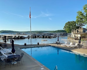 Large heated pool with view of lake and plenty of seating