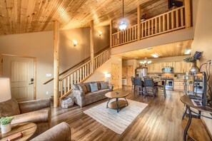 Beautiful living room with a loft located upstairs.