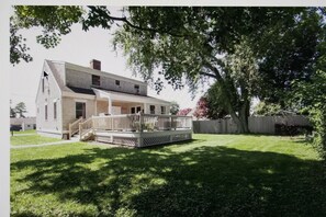 Backyard view of house and deck