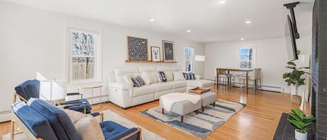 Spacious living room with large screen flat TV.