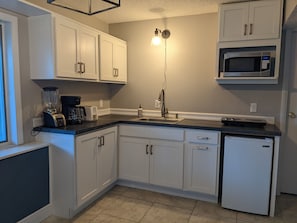 Kitchen has a mini-fridge, microwave, small appliances, etc.