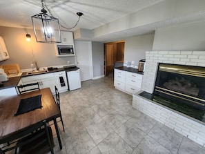 There is a fireplace that goes between the kitchen and the living space.