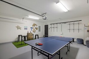 Garage offers a ping pong table, corn hole game & sitting area