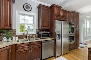 The kitchen is fully equipped with stainless steel appliances and everything you need to prepare gourmet meals.