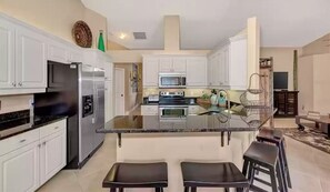 Ample spaced kitchen. Island seats shown. Table for five not shown. Ice maker. 