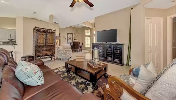 Family room with reclining sofa, comfy chairs and smart tv with streaming. 