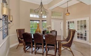Dining room with seating for eight. Den behind double glass doors. 