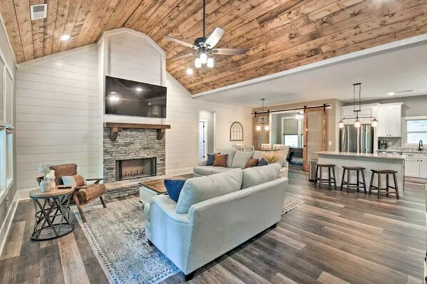 Plentiful seating complete with real wood-burning fireplace and 70” smart TV. 