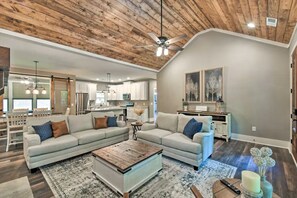 Spacious family room with gorgeous vaulted wooden ceilings. Luxurious decor. 