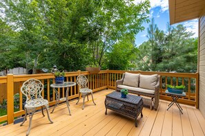 The Back porch with a canopy of trees around it.