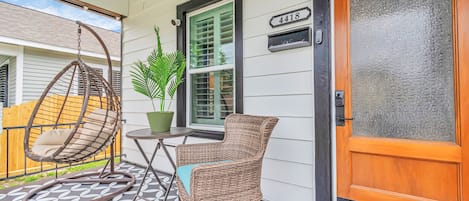 Front porch is picture perfect spot for relaxing and listening to the seabreeze.