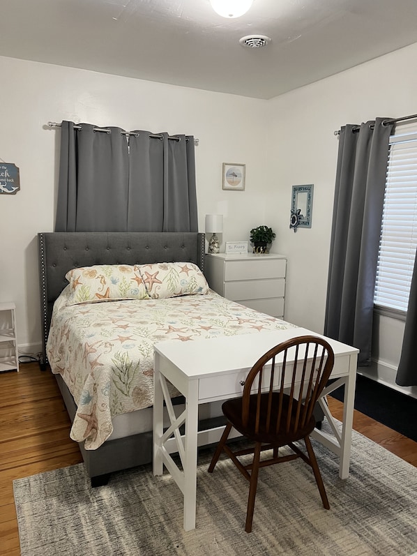 First bedroom. Queen bed. Dresser and closet.