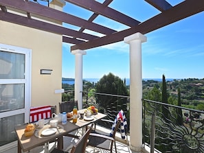 Sky, Property, Table, Window, Tableware, Flowerpot, Building, Shade, Chair, Porch