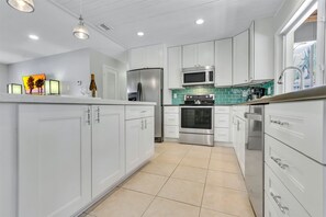 Spacious kitchen renders utmost cooking room for the family chef