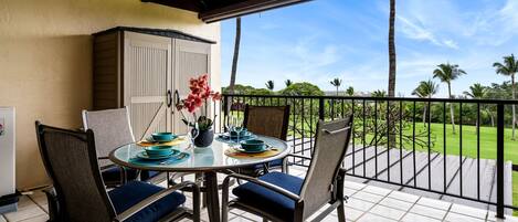 Lanai dining table with ocean and golf course views