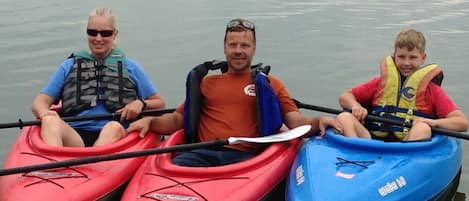 Three one-person kayaks and one fishing kayak for fun on the water.