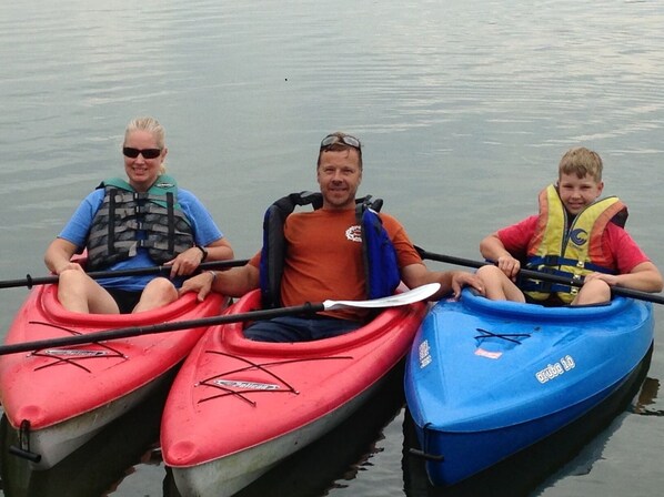 Three one-person kayaks and one fishing kayak for fun on the water.