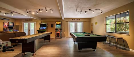 Game room with lots of games and 75 inch smart TV to catch the game or show. 