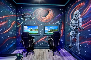 Step into our themed game room, where excitement meets relaxation