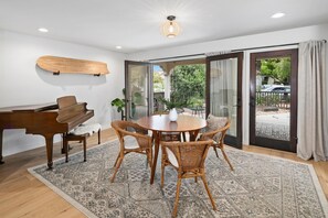 Indoor dining area and baby grand piano