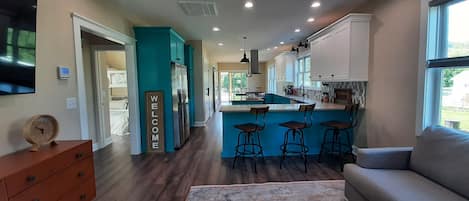 Open concept living room, kitchen and dining area.
