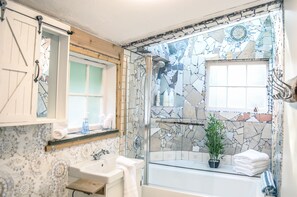 Remodled bathroom with skylight above tub
