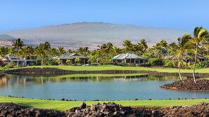 View of the Mauna Lani South Course, a large water feature and Hualalai mountain