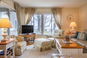 Living area features a comfy sectional and tv.