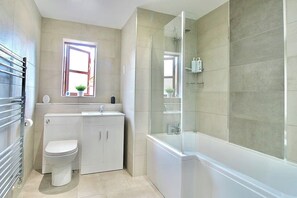 Modern, clean bathroom. Fitted with a high pressure rainfall shower over the bathtub.