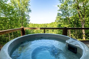 Soak in our hot tub while enjoying captivating views.