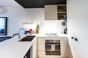 Fully equipped modern kitchen with premium appliances, perfect for home-cooked meals.