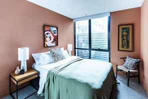 This modern bedroom is filled with natural sunlight, creating a warm and inviting space. Sink into the amazingly comfortable mattress, soft pillows, and hotel-grade linens designed to give you a restful, luxurious night’s sleep.