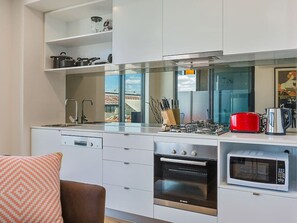 Contemporary kitchen with pots, pans, blender and cooking utensils